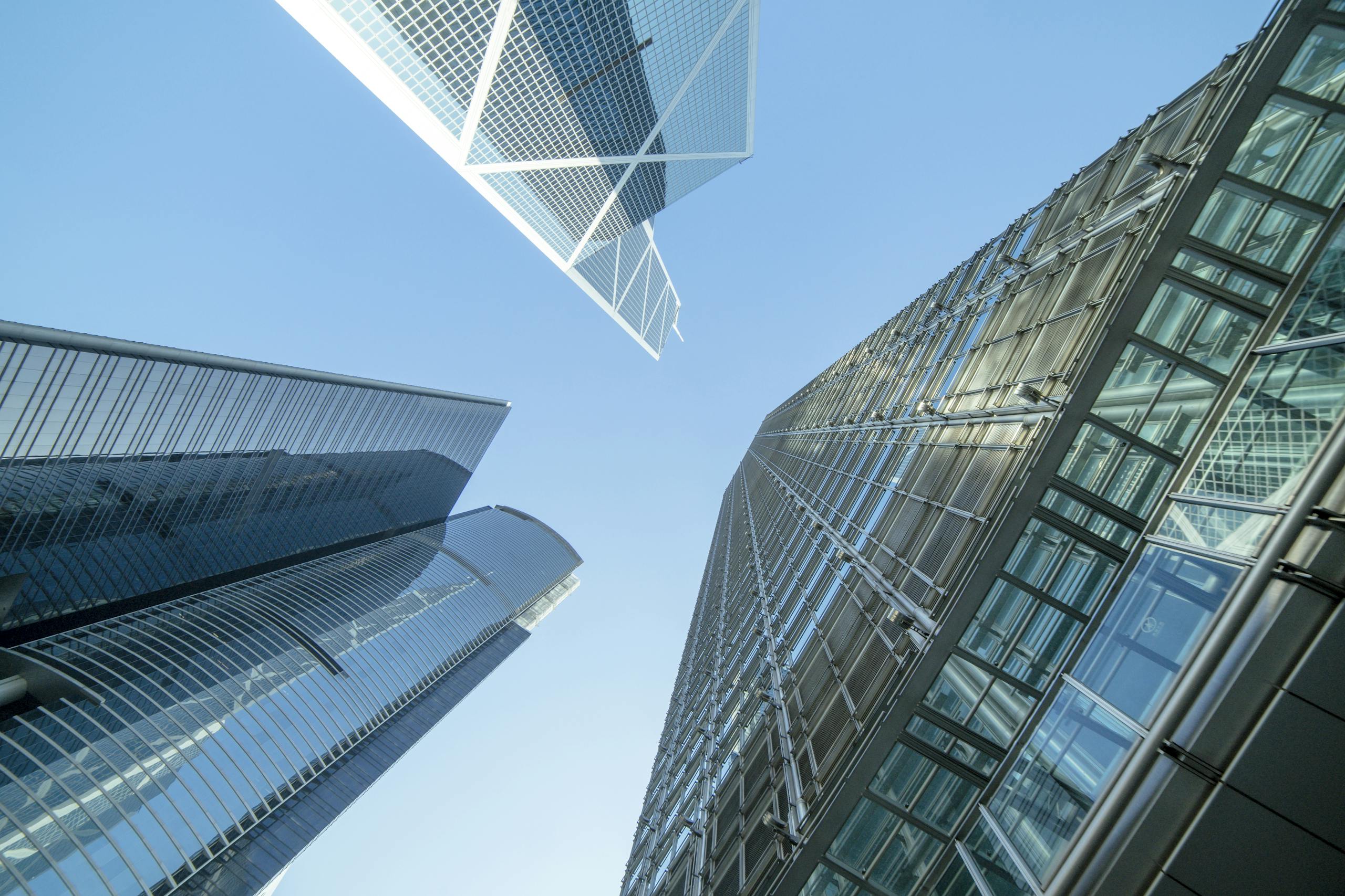 Modern skyscrapers captured from below, showcasing Hong Kong's urban architecture.